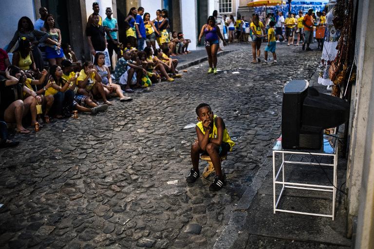 Một cậu bé Brazil Brazil mải mê theo dõi World Cup qua chiếc tivi nhỏ trong một con phố ở Salvador