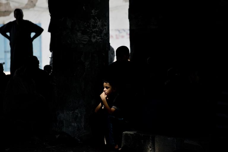 Một cậu bé Palestine ngồi trên đống đổ nát của một nhà thờ Hồi giáo ở thành phố Gaza bị phá hủy, vốn là nơi để các tín đồ địa phương tổ chức lễ cầu nguyện ngày thứ Sáu