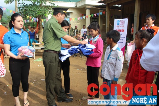 Đồng chí Thượng tá Nguyễn Hoài Nam, Trưởng phòng Bảo vệ Chính trị trao áo ấm cho các em học sinh