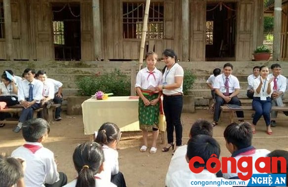 Giáo viên Trường Phổ thông Dân tộc bán trú THCS Mai Sơn trao số tiền hỗ trợ của nhà báo Nguyễn Viết Lam cho em Và Y Mại