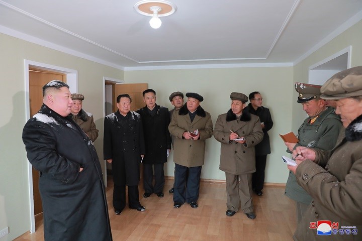 Tuyết vẫn còn vương trên áo khoác của nhà lãnh đạo Triều Tiên Kim Jong-un (bìa trái), người giữ chức vụ Chủ tịch Đảng Lao động Triều Tiên và Chủ tịch Ủy ban Quốc vụ Triều Tiên.