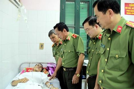 Các đồng chí lãnh đạo đoàn công tác Bộ Công an thăm, động viên Trung úy Lê Văn Tuấn bị thương khi làm nhiệm vụ.