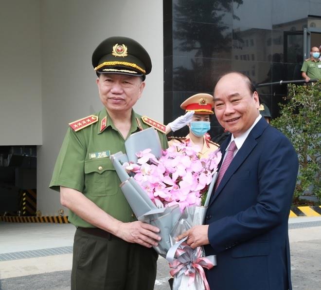 Bộ trưởng Tô Lâm tặng hoa Thủ tướng Nguyễn Xuân Phúc.