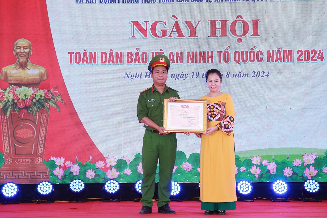 Đồng chí Võ Thị Minh Sinh - Ủy viên Ban Thường vụ Tỉnh ủy, Chủ tịch Ủy ban MTTQ tỉnh trao Bằng khen tặng Công an xã Nghi Hưng