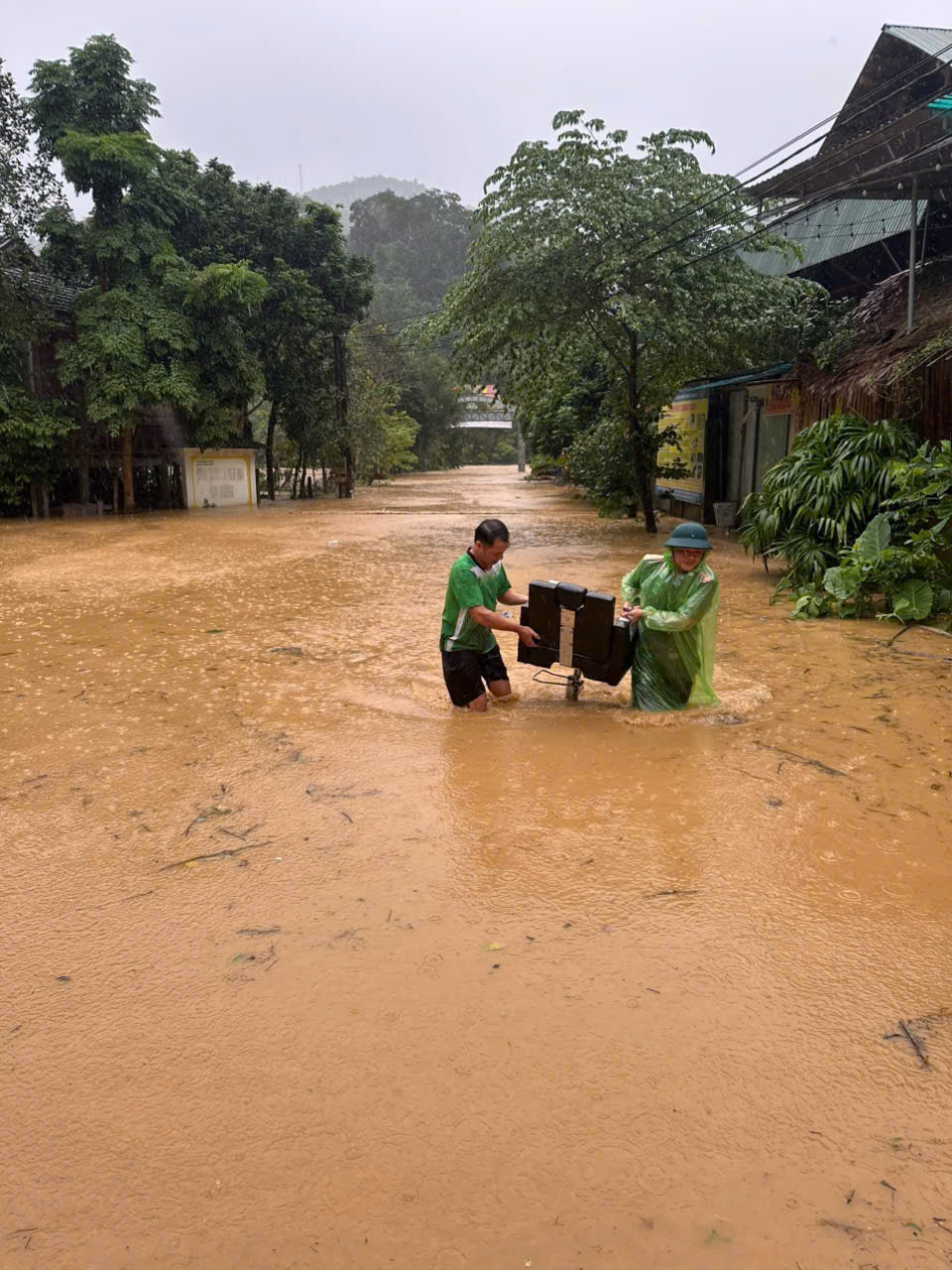 Công an xã Tam Thái dầm mưa hỗ trợ người dân di dời tài sản đến nơi an toàn