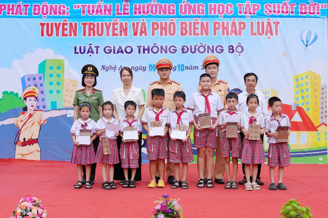 Đồng chí Đại úy Lê Diệu Thúy, Trưởng ban Phụ nữ Công an tỉnh cùng các đại biểu tặng quà các em học sinh có hoàn cảnh khó khăn