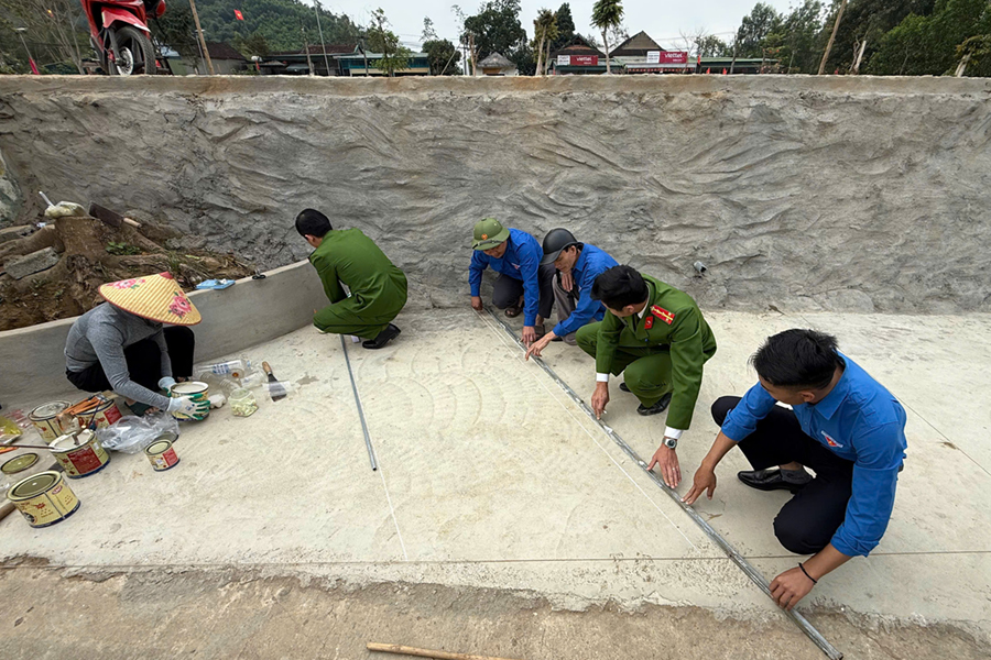 Công an xã phối hợp kẻ vạch dừng xe, phân luồng khu vực đón - trả trẻ tại Trường mầm non Cam Phục