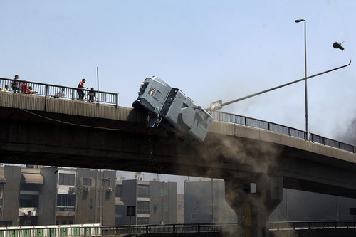 Protesters pushed a police vehicle off a bridge in the Nasr City district of Cairo Wednesday.