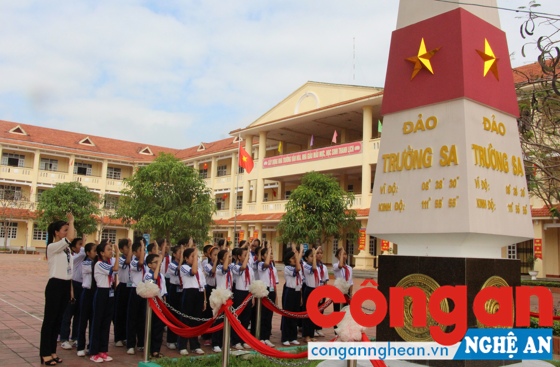 Giáo viên và học sinh Trường THCS Kim Liên thực hiện nghi thức chào mô hình cột mốc chủ quyền đảo Trường Sa