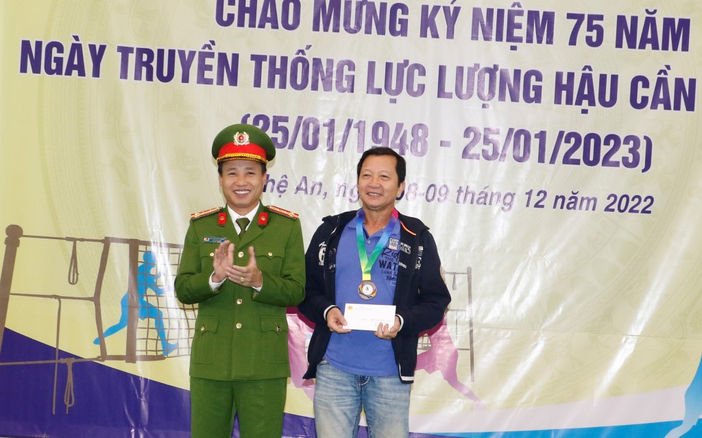 Đồng chí Đại tá Nguyễn Duy Thanh, Phó Giám đốc Công an tỉnh trao quà cho vận động viên Thượng tá Đậu Viết Thọ, Phó Trưởng Công an huyện Thanh Chương là vận động viên nhiều tuổi nhất của giải đấu
